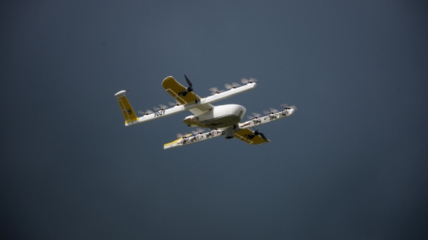An Alphabet Inc. Google X Project Wing delivery drone flies during a demonstration at Virginia Tech in Blacksburg, Virginia, U.S., on Tuesday, Aug. 7, 2018. Project Wing aims to increase access to goods, reduce traffic congestion in cities, and help ease Carbon dioxide emissions.
