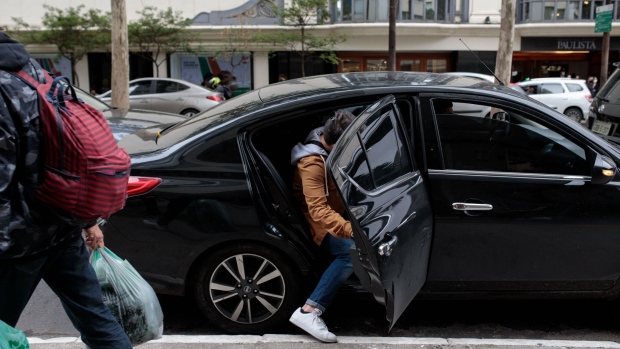 An Uber Technologies Inc. driver picks up a passenger in Sao Paulo, Brazil, on Sunday, Oct. 17, 2021. Uber is now allowing some users in Brazil to pay more for shorter wait times, as high gas prices have led to a dearth of drivers. Photographer: Patricia Monteiro/Bloomberg