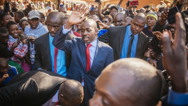 Nelson Chamisa, leader of the Movement for Democratic Change (MDC), center, waves to supporters as he arrives to cast his vote at a polling station in the Kuwadzana township, in Harare, Zimbabwe, on Monday, July 30, 2018. After nearly two decades of political turmoil, a credible vote would help provide the southern African nation with a foundation to begin rebuilding its battered international reputation and an economy largely laid to ruin during the latter half of Robert Mugabe's 37-year rule.