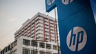 The HP Inc. logo with the backdrop of office buildings at Nehru Place IT Market in New Delhi, India, on Sunday, Dec. 12, 2021. India's consumer price inflation likely picked up in November for a second month in a row with core inflation likely to have increased to 5.3% from 5.2% in October as companies have started raising retail prices to pass on higher input costs to consumers, according to media reports.