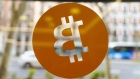 A reversed Bitcoin logo in the window of a cryptocurrency exchange in Madrid, Spain, on Thursday, March 17, 2022. Bitcoin edged higher following reassurance from Federal Reserve Chairman Jerome Powell that the U.S. economy was strong enough to weather tightening monetary policy. Photographer: Angel Navarrete/Bloomberg