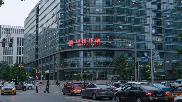 Vehicles travel past the China Huarong Asset Management Co. headquarters on Financial Street in Beijing, China, on Wednesday, May 19, 2021. Beijing aced its economic recovery from the pandemic largely via an expansion in credit and a state-aided construction boom that sucked in raw materials from across the planet. Photographer: Yan Cong/Bloomberg