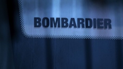A Bombardier logo on the window of a Stuttgart S-Bahn passenger train on the assembly line at the Bombardier Inc. factory in Hennigsdorf, Germany, on Wednesday, Nov. 18, 2020. Bombardier announced a deal earlier this year to divest its train unit to Alstom SA for $8.4 billion.