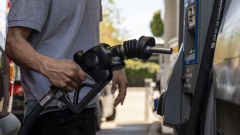 A driver returns a fuel nozzle to a gas pump at a Chevron gas station in San Francisco, California, U.S., on Monday, March 7, 2022. The average price of gasoline in the U.S. jumped above $4 a gallon for the first time since 2008 in a clear sign of the energy inflation that's hurt consumers since Russia invaded Ukraine.