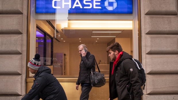Pedestrians pass a Chase bank branch in New York, U.S., on Thursday, Jan. 13, 2022. JPMorgan Chase & Co. posted a decline in trading revenue that was steeper than analysts expected, and both commercial and consumer loans fell from a year earlier.
