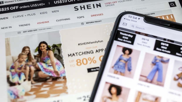 The SheIn application and website arranged on a smartphone and a tablet in Hong Kong, China, on Friday, May 21, 2021. As with so many online phenomena, Gen Z and young millennial shoppers have propelled Shein's rise, in thrall to the company's never-ending, always-changing catalog of clothes at prices that stretch even the most meager allowance.