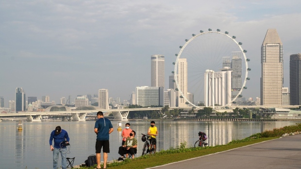 A park opposite the central business district at Marina Bay in Singapore, on Sunday, Oct. 3, 2021. Singapore is looking to launch new vaccinated travel lanes by the end of the year and is in negotiations with several countries including those in Europe and also the U.S., Trade Minister Gan Kim Yong said, signaling continued caution even as other advanced economies open up. Photographer: Ore Huiying/Bloomberg