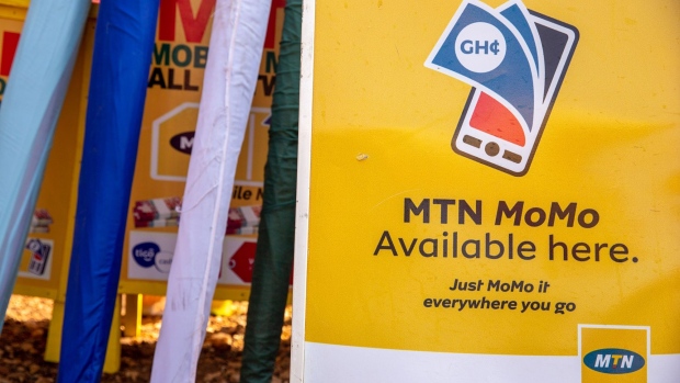 A sign advertising the MTN Group Ltd. MoMo mobile money payment service in Accra, Ghana, on Tuesday, April 22, 2021. MTN Group Ltd. values its mobile-money arm at about $5 billion and will consider a listing of the division, joining African wireless carriers trying to monetize a service that is particularly popular on the continent. Photographer: Nipah Dennis/Bloomberg