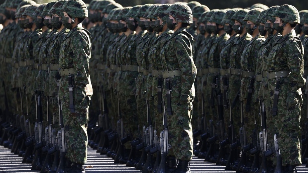 Members of the Japan Ground Self-Defense Force (JGSDF) stand in formation during a review at JGSDF Camp Asaka in Tokyo, Japan, on Saturday, Nov. 27, 2021. Japan is planning its biggest-ever allocation to defense spending in an extra budget, as it seeks to speed up missile defense projects with China tensions simmering.