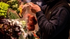 A vendor bags fresh tomatoes for a customer at the La Boqueria food market in Barcelona, Spain, on Friday, Dec. 10, 2021. Spanish inflation accelerated to the fastest in nearly three decades in November on rising food prices, underscoring the lingering consequences of supply-chain bottlenecks across Europe.