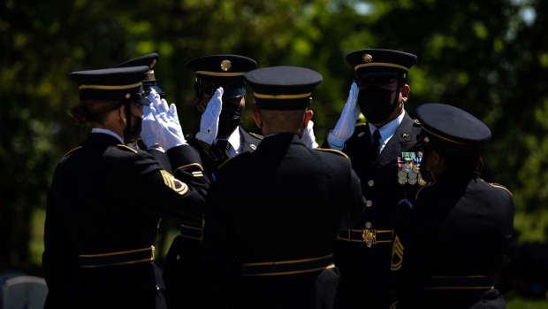 Members of the Honor Guard salute the peaked caps of all US armed forces on the fallen comrade table during a Memorial Day ceremony in the Fort Knox Main Post Cemetery on May 31, 2021 in Fort Knox, Kentucky. 