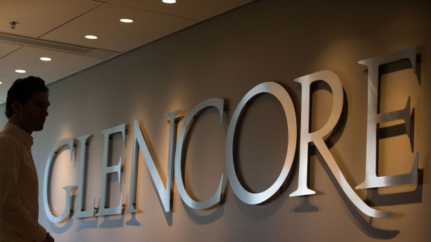 An employee stands by a logo for Glencore Agriculture in Glencore Plc's offices in Rotterdam, Netherlands, on Tuesday, April 25, 2017. Since taking over Glencore Agriculture in 2002, Chris Mahoney has overseen the transformation of the unit into a standalone enterprise that generates more revenue from owning fixed assets in strategic locations than simply trading. Photographer: Simon Dawson/Bloomberg