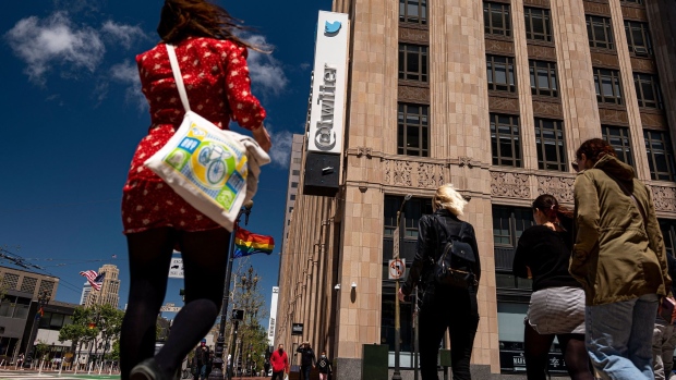 People cross the street in front of the Twitter Inc. headquarters in San Francisco, California, U.S., on Wednesday, June 9, 2021. California officials plan to fully reopen the economy on June 15, if the pandemic continues to abate, after driving down coronavirus case loads in the most populous U.S. state.