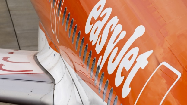 A sign on the fuselage of a passenger aircraft, operated by Easyjet Plc, at London Luton Airport in Luton, U.K., on Monday, May 10, 2021. The U.K. governments decision to loosen border rules frees Britons to feed their pent-up appetite for leisure travel. Photographer: Jason Alden/Bloomberg