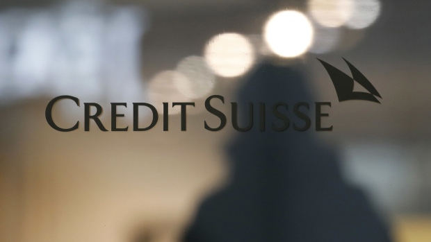 A Credit Suisse company logo at the entrance to a Credit Suisse Group AG bank branch in Bern, Switzerland, on Monday, Feb. 15, 2021. Credit Suisse is expecting to post a fourth-quarter loss when it reports earnings on Feb. 18, after setting aside $850 million for U.S. legal cases including MBIA and booking a $450 million impairment on a hedge fund investment. Photographer: Stefan Wermuth/Bloomberg