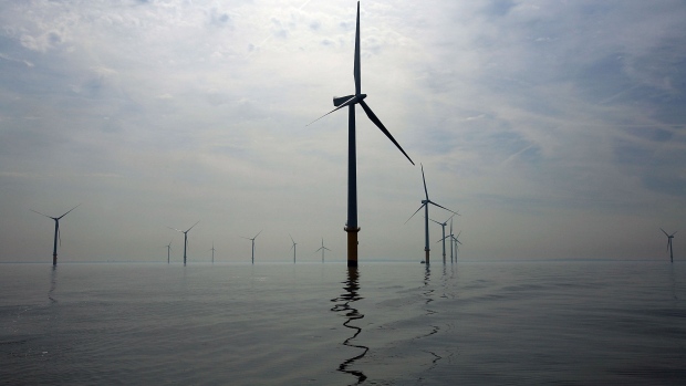 LIVERPOOL, UNITED KINGDOM - MAY 12: Turbines of the new Burbo Bank off shore wind farm stand in a calm sea in the mouth of the River Mersey on May 12, 2008 in Liverpool, England. The Burbo Bank Offshore Wind Farm comprises 25 wind turbines and is situated on the Burbo Flats in Liverpool Bay at the entrance to the River Mersey, approximately 6.4km (4.0 miles) from the Sefton coastline and 7.2km (4.5 miles) from North Wirral. The wind farm is capable of generating up to 90MW (megawatts) of clean, environmentally sustainable electricity. This is enough power for approximately 80,000 homes. The site is run by Danish energy company Dong Energy. (Photo by Christopher Furlong/Getty Images)
