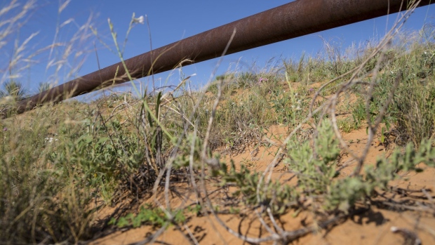 An exposed gas pipeline at a cattle ranch in Crane County, Texas, U.S., on Friday, June 18, 2021. Long before the advent of shale drilling techniques that fueled the greatest move toward energy independence the nation’s ever seen, conventional oil explorers left the country pierced with millions of defunct wells that are aging by the day and increasingly springing leaks. Photographer: Matthew Busch/Bloomberg