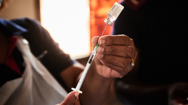 A health worker prepares a dose of the Johnson & Johnson Covid-19 vaccine during a rural vaccination drive by Broadreach NGO at Duduzile Secondary School in Mpumalanga, South Africa, on Wednesday, March 9, 2022. Excess deaths during the Covid-19 pandemic, seen as a more accurate way of measuring its impact than official statistics, climbed to 301,106 in the week ended March 5, according to South African Medical Research Council data. Photographer: Waldo Swiegers/Bloomberg
