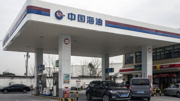 Vehicles refuel at a Cnooc Ltd. gas station in Shanghai, China, on Thursday, Jan. 7, 2021. China's energy markets are tightening as the economy rebounds and freezing weather grips much of the northern hemisphere, a dynamic that’s likely to be exacerbated by reduced Saudi oil output.