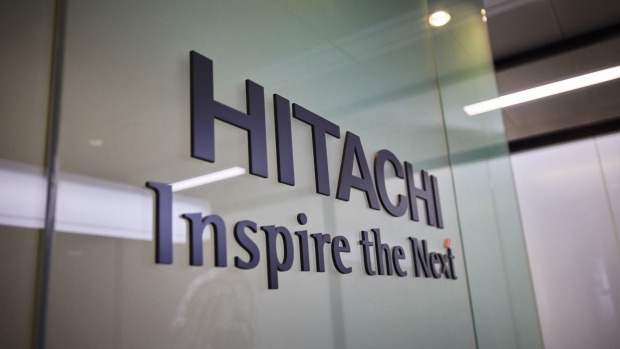 The logo of Hitachi Ltd. displayed at the company's headquarters in Tokyo, Japan, on Jan. 18, 2022. Hitachi is ready to sell its 40% stake in Hitachi Transport System but wants to find the right industry partner, according to Chief Executive Officer Toshiaki Higashihara. Photographer: Shoko Takayasu/Bloomberg