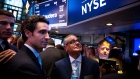 Ernie Garcia III, founder and chief executive officer of Carvana Co., second left, and his father Ernest Garcia II, chairman of Carvana Co., center, stand during the company's initial public offering (IPO) on the floor of the New York Stock Exchange (NYSE) in New York, U.S., on Friday, April 28, 2017. U.S. stocks remained near record highs, Treasuries dropped and oil closed in on $50 a barrel even after the world's biggest economy reported its slowest pace of expansion in three years.