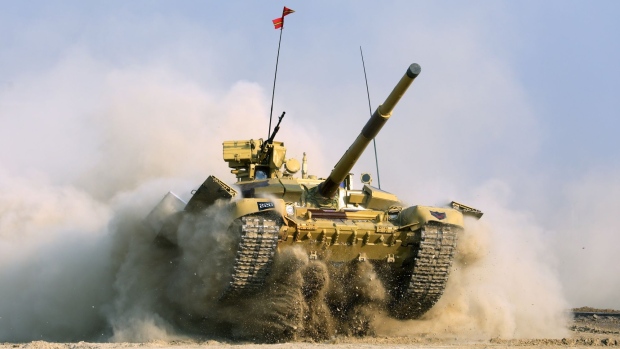 An Indian Army Bhishma T-90 battle tank performs an operation demonstration during the DefExpo 20 in Lucknow, Uttar Pradesh, India, on Wednesday, Feb. 5, 2020. India plans to spend $250 billion over a 10-year period to 2025 on defense modernization. Combat jets, submarines, battle tanks and armored vehicles are among the procurement programs that Prime Minister Narendra Modi’s administration is pursuing. Photographer: T. Narayan/Bloomberg