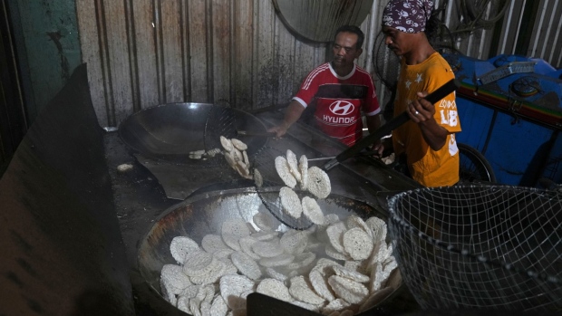 Workers deep fry Kerupuk crackers at Kerupuk SKS factory in Jakarta, Indonesia, on Wednesday, April 20, 2022. The deep-fried crackers served usually alongside every Indonesian meal are set to cost twice as much starting next month due to higher prices of cooking oil and spices, in the latest sign of how inflation is creeping into Southeast Asia’s biggest economy.