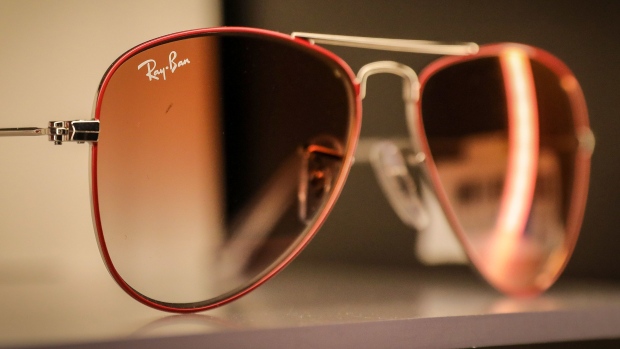 A Ray-Ban logo on a pair of sunglasses, manufactured by EssilorLuxottica SA, on display inside a Ray-Ban store, in Barcelona, Spain, on Wednesday, June 30, 2021. EssilorLuxottica will go ahead with its planned 7.3 billion-euro ($8.7 billion) purchase of Dutch eyewear retailer GrandVision NV at the previously agreed price, ending a dispute between the two sides after the pandemic laid waste to parts of the consumer industry. Photographer: Angel Garcia/Bloomberg