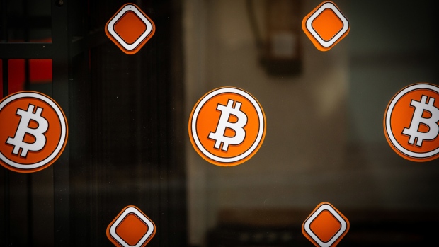 Bitcoin logos on the window of a cryptocurrency kiosk in Barcelona, Spain, on Wednesday, March 9, 2022. Bitcoin dropped back below $40,000, erasing almost all the gains sparked by optimism about U.S. President Joe Biden’s executive order to put more focus on the crypto sector. Photographer: Angel Garcia/Bloomberg