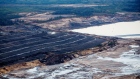 The Albian Sands Energy Inc. Muskeg River mine is seen in this aerial photograph taken above the Athabasca oil sands near Fort McMurray, Alberta, Canada, on Monday, Sept. 10, 2018. While the upfront spending on a mine tends to be costlier than developing more common oil-sands wells, their decades-long lifespans can make them lucrative in the future for companies willing to wait.