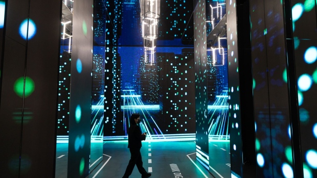 A visitor walks through the KT Corp. booth in the World IT Show 2022 in Seoul, South Korea, on Thursday, April 21, 2022. The show runs through April 22.