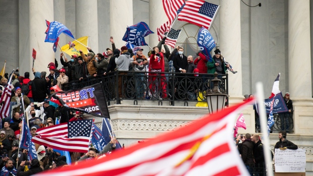 Demonstrators enter the U.S. Capitol after breaching security fencing during a protest in Washington, D.C., U.S., on Wednesday, Jan. 6, 2021. The U.S. Capitol was placed under lockdown and Vice President Mike Pence left the floor of Congress as hundreds of protesters swarmed past barricades surrounding the building where lawmakers were debating Joe Biden's victory in the Electoral College.