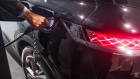 A worker plugs in a charger to a DS 3 Crossback e-tense electric sports utility vehicle (SUV) in a Citroen showroom, operated by Stellantis NV, in Paris.