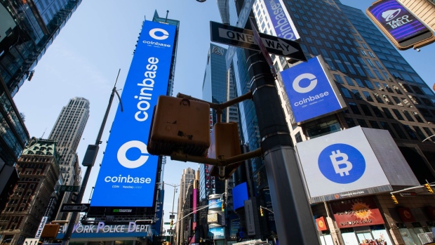 Monitors display Coinbase signage during the company's initial public offering (IPO) at the Nasdaq MarketSite in New York, U.S., on Wednesday, April 14, 2021. Coinbase Global Inc., the largest U.S. cryptocurrency exchange, is set to debut on Wednesday through a direct listing, an alternative to a traditional initial public offering that has only been deployed a handful of times. Photographer: Michael Nagle/Bloomberg