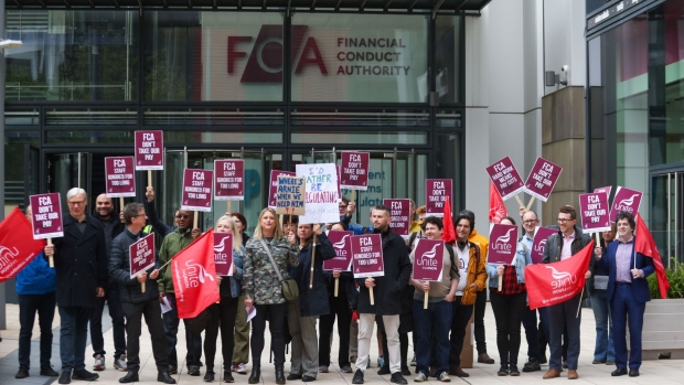 A member of staff at the Financial Conduct Authority holds a placard during strike in a dispute over pay and conditions outside their offices in London, U.K., on Wednesday, May 4, 2022. Staff at the watchdog “have made it very clear that the proposed changes to staff pay and conditions are completely unacceptable,” Sharon Graham, Unite general secretary, said when the union voted to strike.