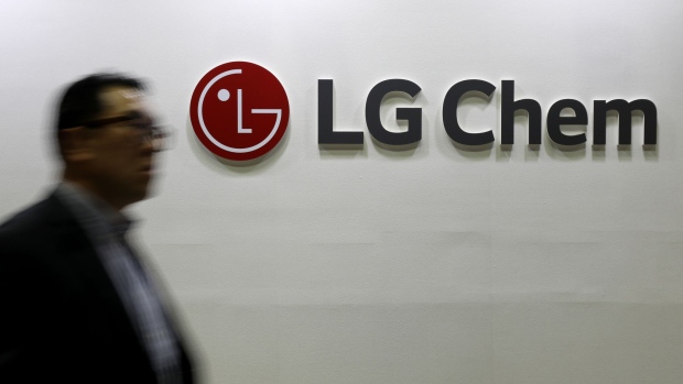 An attendee walks past the LG Chem Ltd. logo displayed at the company's booth at the EV Trend Korea exhibition in Seoul, South Korea, on Thursday, April 12, 2018. The exhibition runs through April 15.
