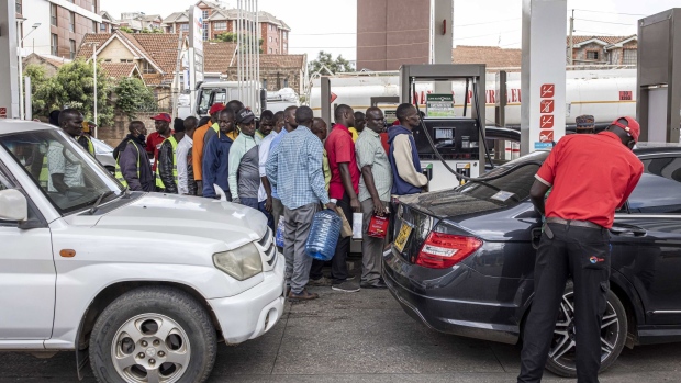 Drivers queue to fill cans with fuel at a gas station in Nairobi, Kenya, on Wednesday, April 13, 2022. Kenya agreed to compensate oil marketers for selling fuel they imported at rates higher than what’s reflected in the retail cap, a bid to end a supply shortage in the country.