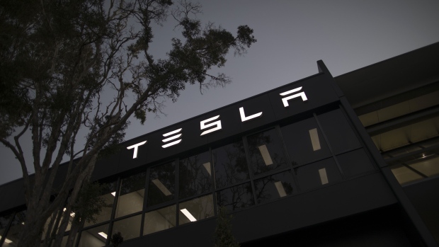 Signage at a Tesla Inc. showroom and service center in Sydney, Australia, on Monday, April 12, 2021. Tesla and the electric-car industry generally thrive in the world’s richest nations. Not so in Australia, where even tractors outsell EVs two to one. Photographer: Brent Lewin/Bloomberg