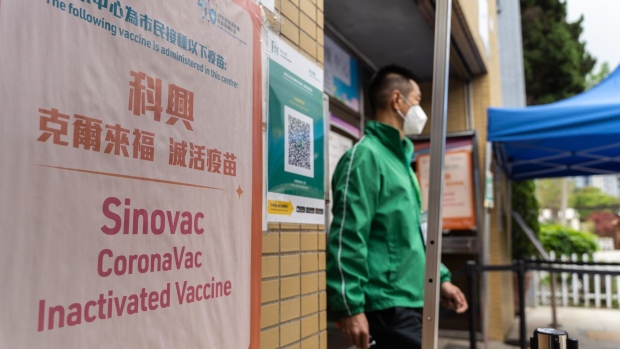 A poster indicating the administration of Sinovac Biotech Ltd. Covid-19 vaccine outside a community vaccination center in Hong Kong, China, on Saturday, April 24, 2021. Hong Kong expanded eligibility for Covid-19 vaccines to all residents aged 16 and older, in the government’s latest attempt to boost the financial hub’s low inoculation rate by making the shots more widely accessible. Photographer: Chan Long Hei/Bloomberg