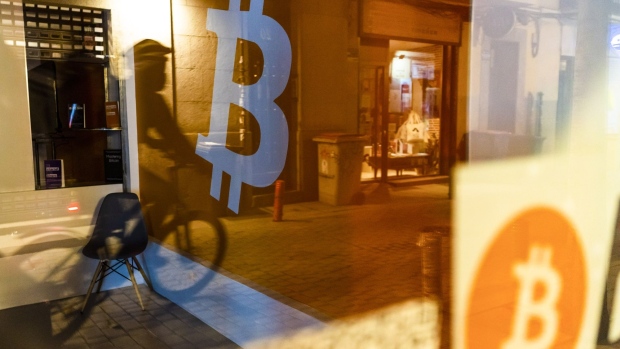 A Bitcoin logo inside a cryptocurrency kiosk in Madrid, Spain, on Thursday, March 17, 2022. Bitcoin edged higher following reassurance from Federal Reserve Chairman Jerome Powell that the U.S. economy was strong enough to weather tightening monetary policy. Photographer: Angel Navarrete/Bloomberg