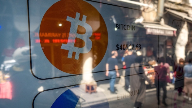 A Bitcoin logo on a screen in the window of a cryptocurrency exchange kiosk in Istanbul, Turkey, on Tuesday, April 26, 2022. Both tech stocks and Bitcoin have notched big swings this year as the Federal Reserve becomes less accommodative as part of its fight to combat inflation. Photographer: Erhan Demirtas/Bloomberg