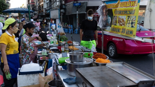 Vendors prepare food at street stalls near Khaosan Road in Bangkok. Photographer: Luke Duggleby/Bloomberg