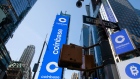 Monitors display Coinbase signage during the company's initial public offering (IPO) at the Nasdaq MarketSite in New York.