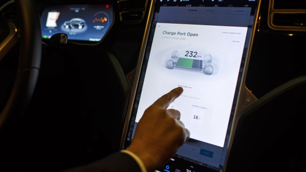 An Uber Technologies Inc. driver uses the touch-sensitive digital control screen inside a Tesla Motors Inc. Model S electric automobile in Madrid, Spain, on Friday, Jan. 13, 2017. Ride-hailing service Uber Technologies has launched its first electric car taxi service in Madrid, operating a fleet of Tesla Model S electric vehicles. Photographer: Angel Navarrete/Bloomberg