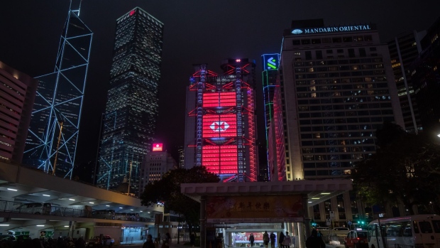The illuminated HSBC Holdings Plc headquarters, center, at night in Hong Kong, China, on Friday, Feb. 18, 2022. HSBC is scheduled to release earnings results on Feb. 22.
