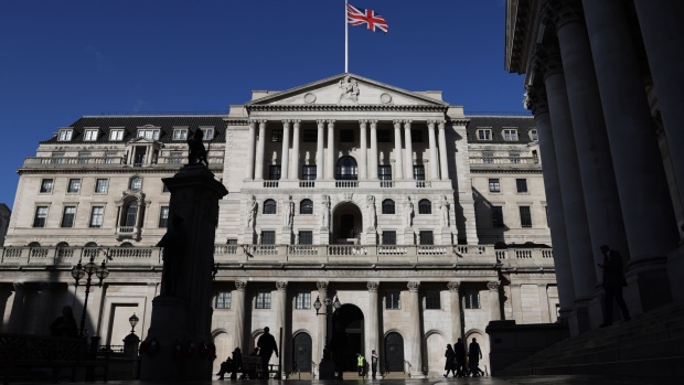 A British Union flag above the Bank of England in the City of London, U.K., on Wednesday, Oct. 20, 2021. The U.K. Treasury is resisting pressure to increase spending in next week's budget because of concern that doing so would backfire by prompting the BOE to raise interest rates more aggressively. Photographer: Hollie Adams/Bloomberg