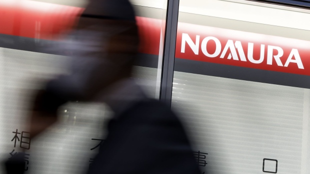 Signage for Nomura Holdings Inc. outside a Nomura Securities Co. branch at dusk in Tokyo, Japan, on Monday, April 25, 2022. Nomura Holdings is scheduled to release earnings figures on April 25. Photographer: Kiyoshi Ota/Bloomberg