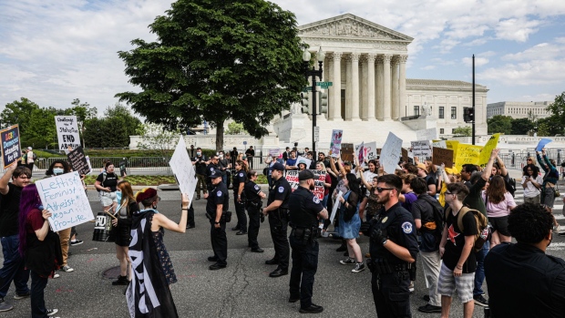 Capitol Police officers separate abortion rights demonstrators and anti-abortion rights demonstrators outside the U.S. Supreme Court in Washington, D.C., U.S., on Wednesday, May 4, 2022. Overturning Roe v. Wade, following the leak of a draft opinion overturning the abortion-rights ruling, risks widening economic inequality in the U.S. threatening decades of gains for women in places where abortion could be all but banned.