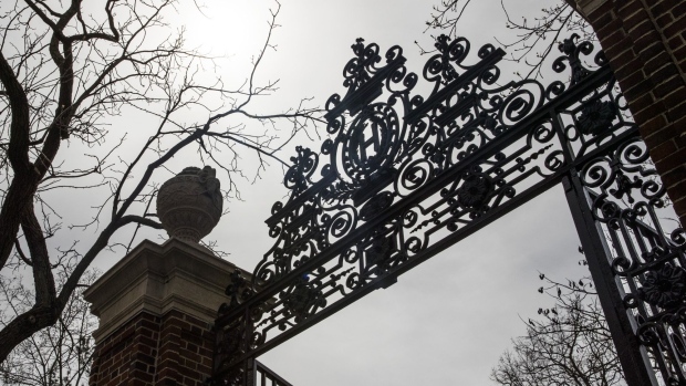 A gate stands in front of Harvard Yard on the closed Harvard University campus in Cambridge, Massachusetts, U.S., on Monday, April 20, 2020. College financial aid offices are bracing for a spike in appeals from students finding that the aid packages they were offered for next year are no longer enough after the coronavirus pandemic cost their parents jobs or income. Photographer: Adam Glanzman/Bloomberg