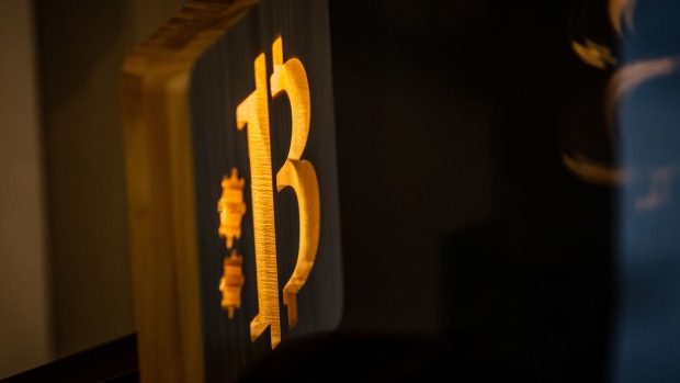 An illuminated wooden Bitcoin logo inside a cryptocurrency exchange in Barcelona, Spain, on Wednesday, March 9, 2022.